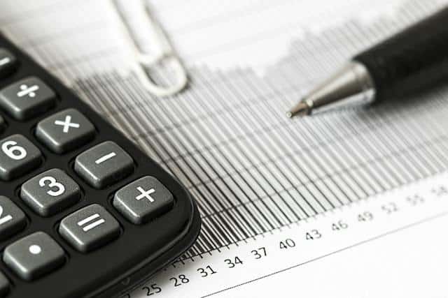 A closeup of a pen and a calculator.